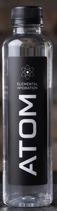 ATOM bottle with a vertical wordmark label